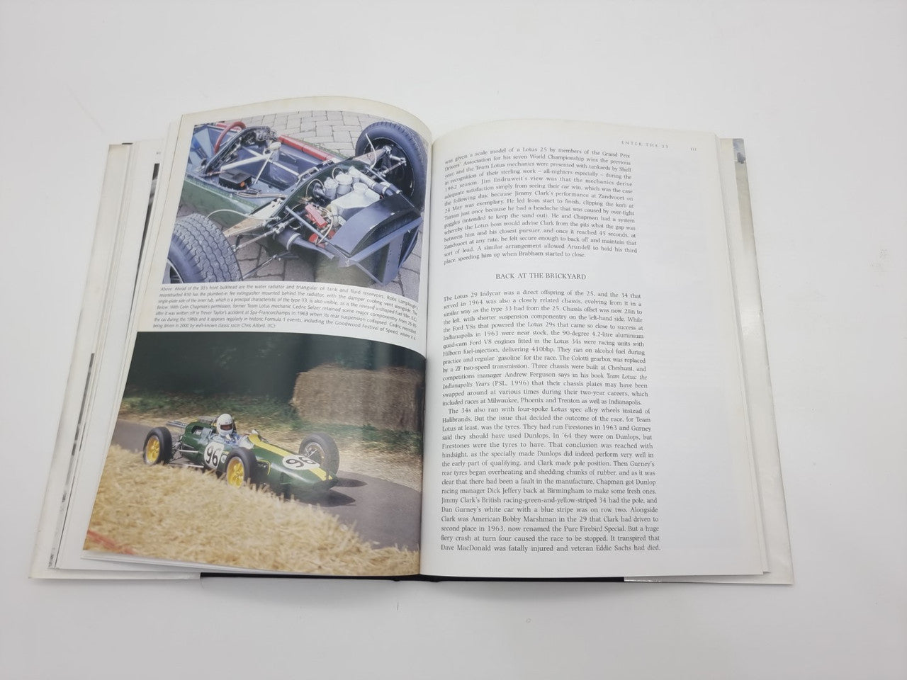 Open motorsport book with grayscale engine bay photo and action shot on left