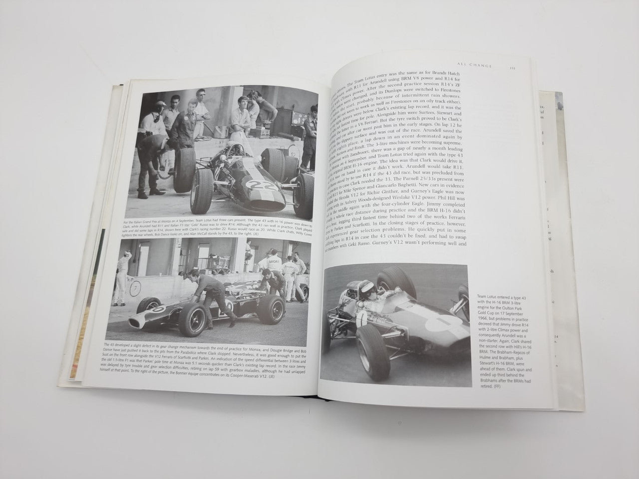 Open book spread with black-and-white race photos and paragraphs of text