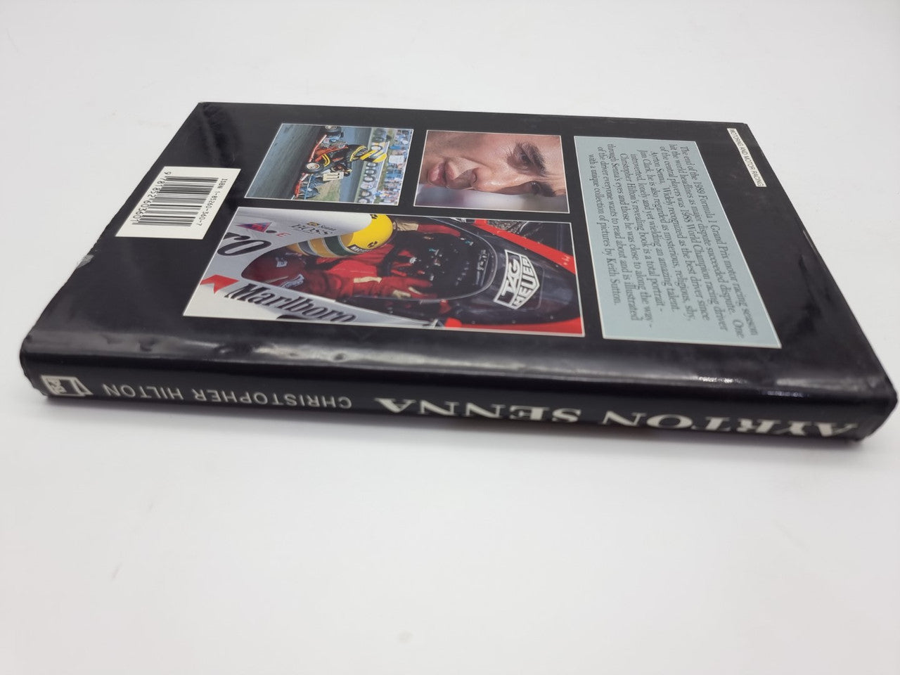 Paperback book front cover with racing collage and barcode on the side