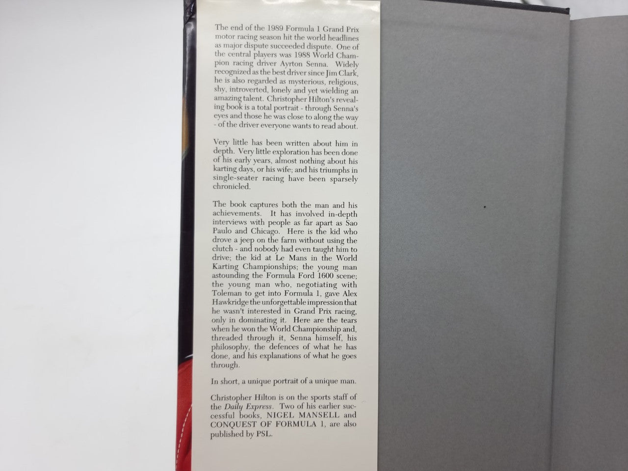Paperback book page with printed biography text in paragraph columns