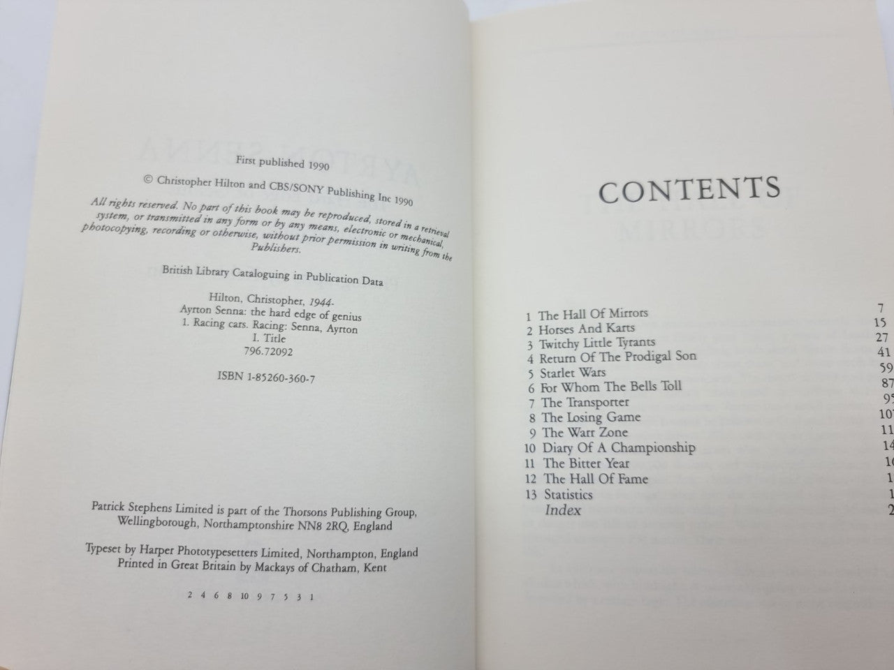 Paperback book open to contents page with numbered sections and headings