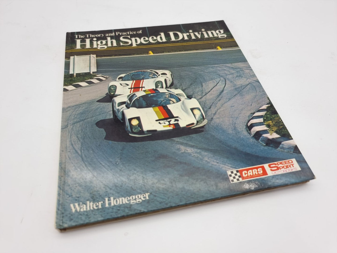 Automotive racing book cover with photo of sports car on track