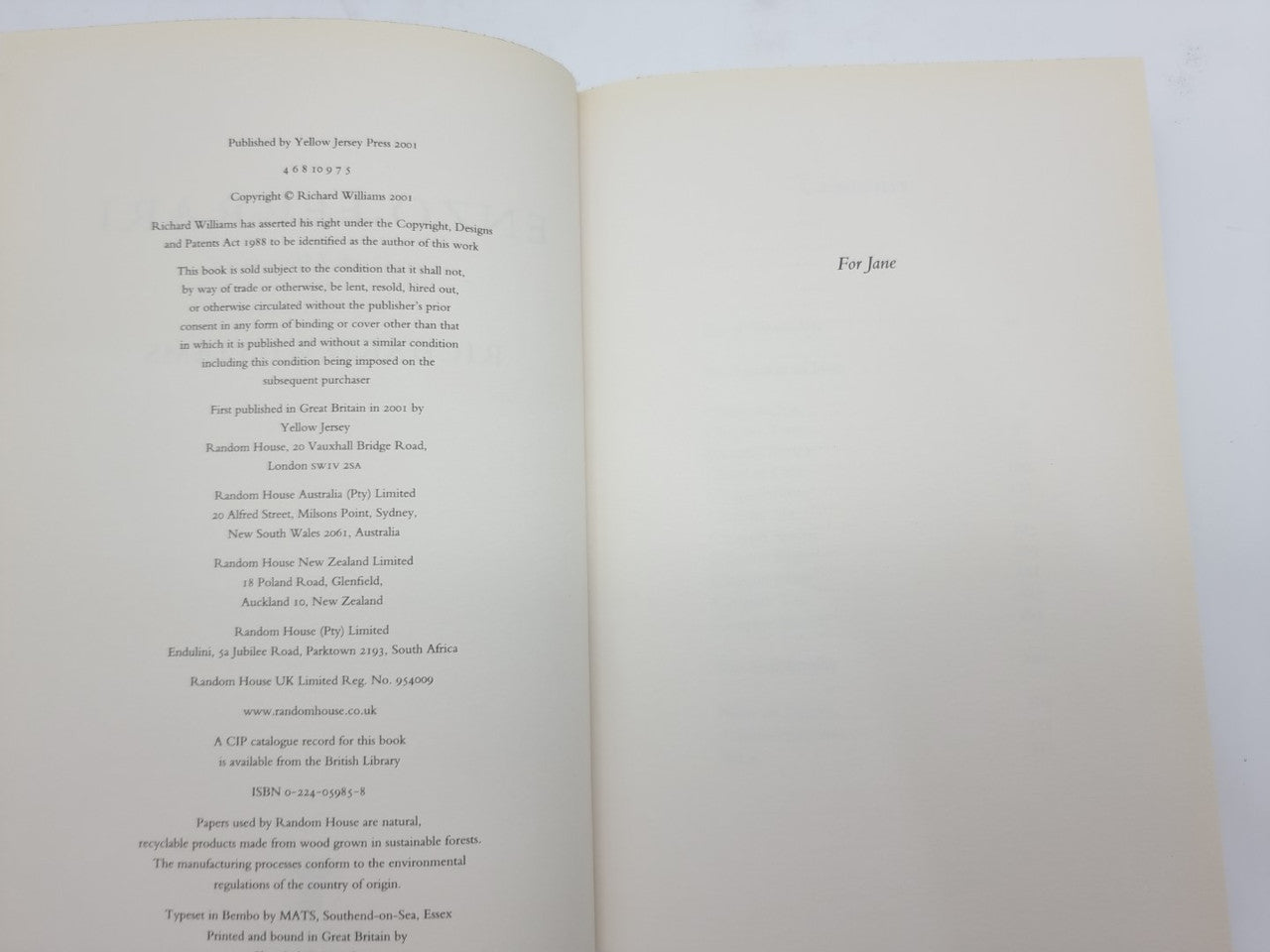 Open book with printed text on the left page and a blank right page