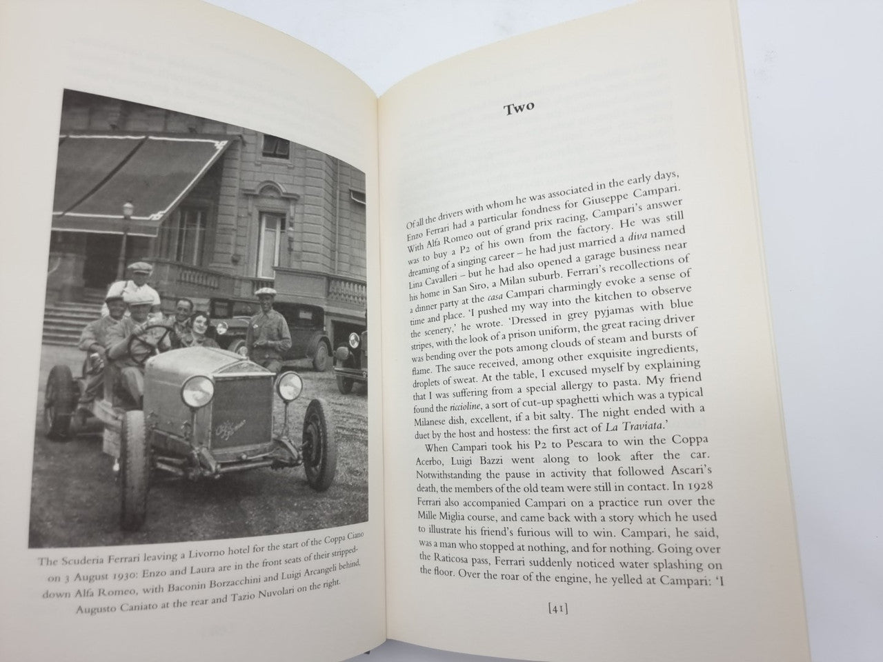 Open book pages with black-and-white car photo on the left and text on the right