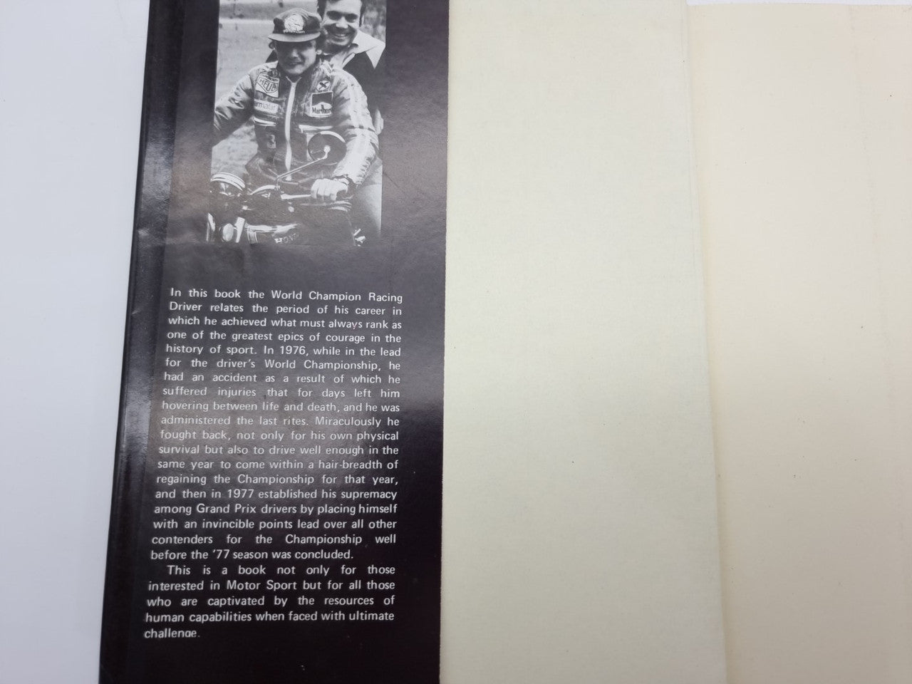 Book page spread with black-and-white portrait photo and text on the left page.