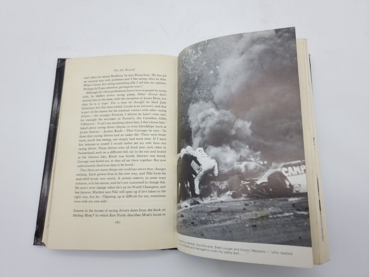 Opened book spread with dense text on left and a black-and-white action photo on right.