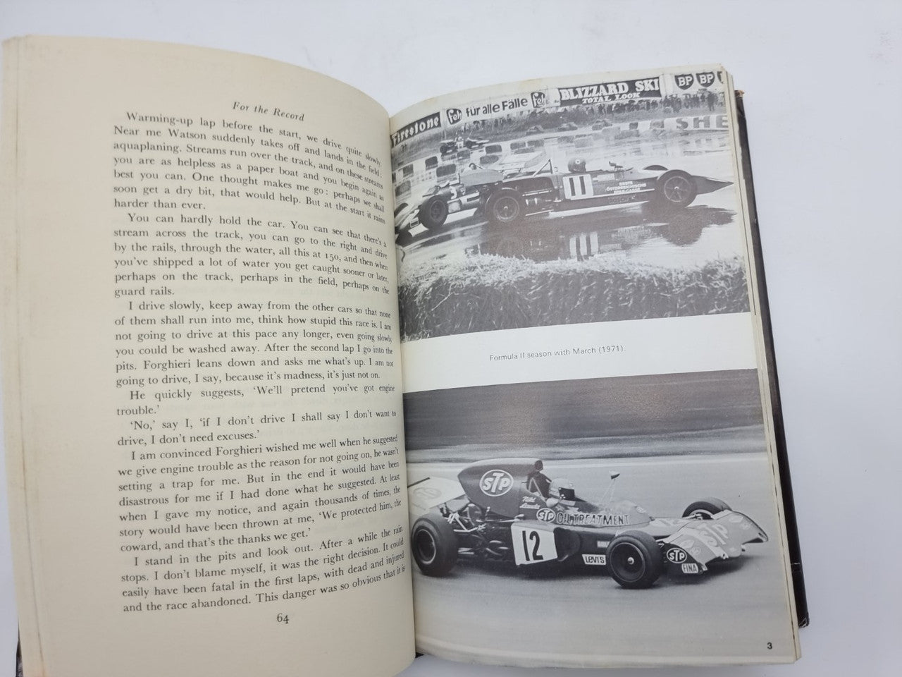 Opened book pages with text on left and a black-and-white race car photo on right.