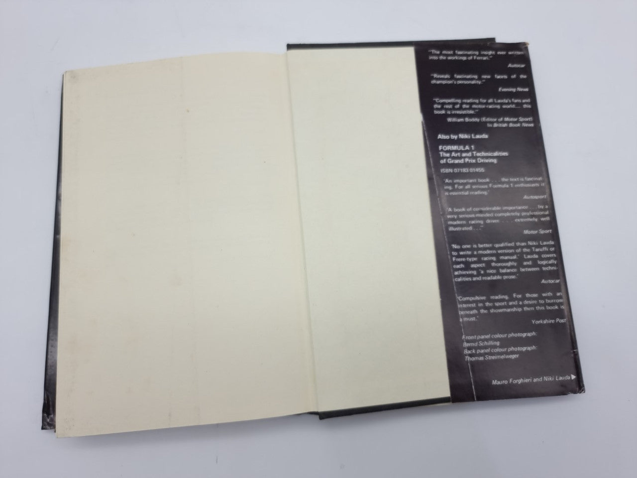 Opened hardcover memoir book with cream pages and a dark vertical info panel.