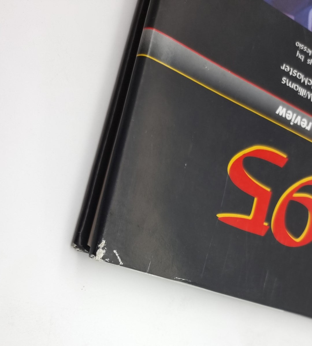 Photographic review book corner with worn black spine and red F1 lettering.
