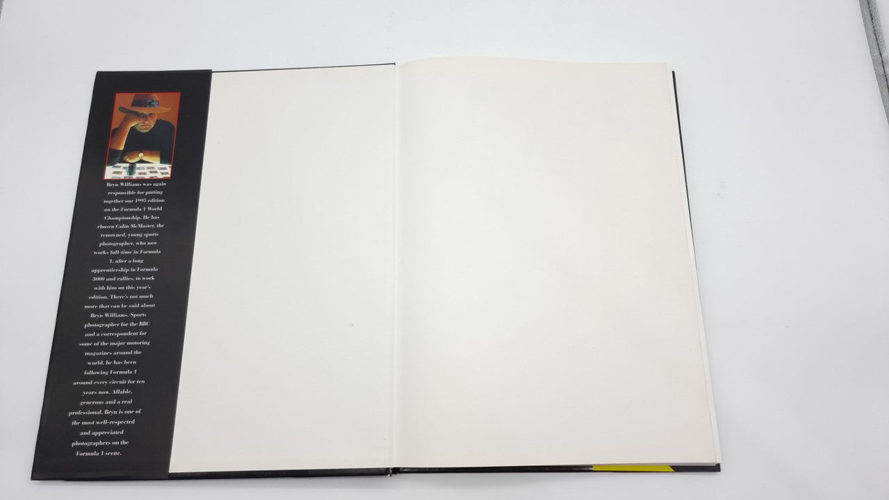 Photographic review book open to blank white pages with book spine visible.