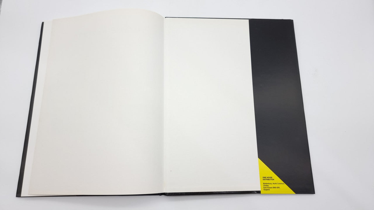 Photographic review book open to blank pages with black end section and yellow label strip