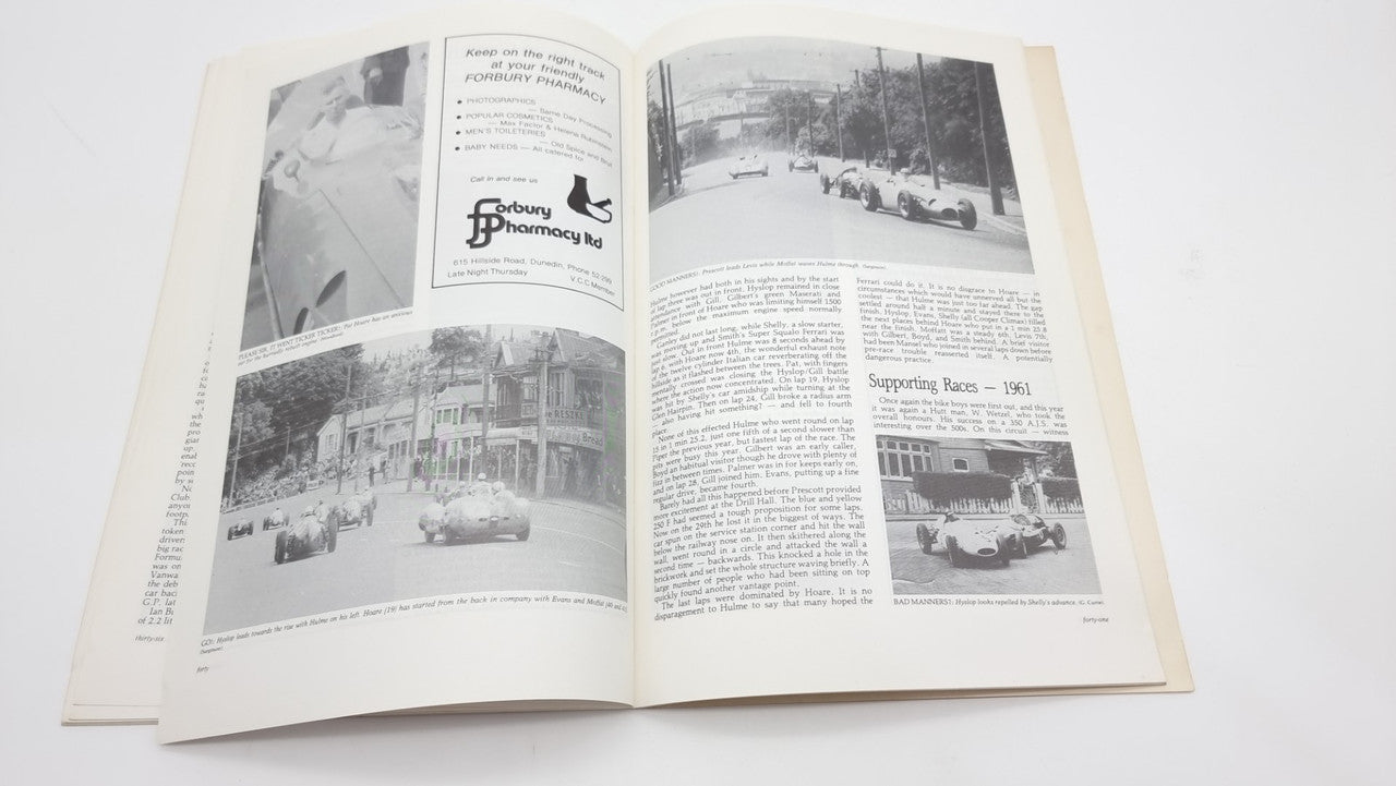 Open race-history book spread with black-and-white photos and caption blocks