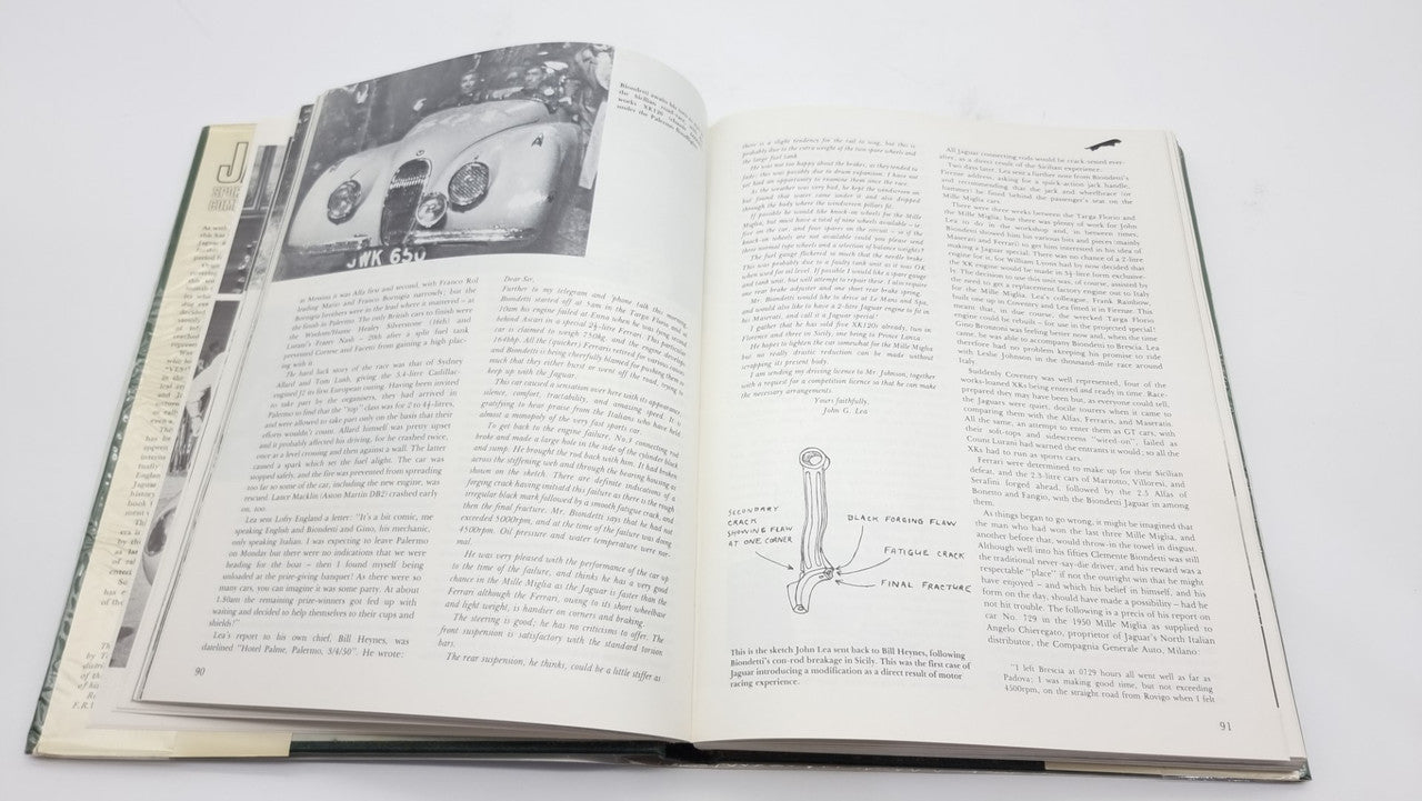 Jaguar sports racing book, open pages with black-and-white racing photos and paragraph text