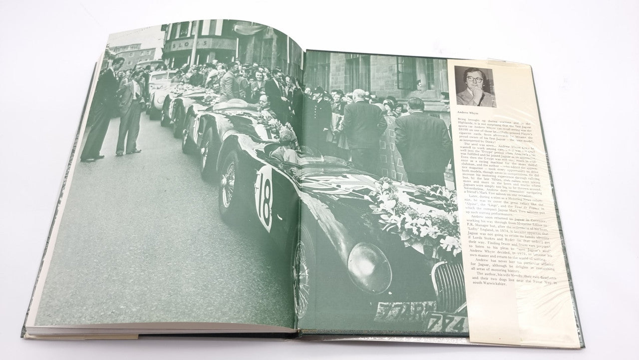 Racing cars history book, open pages with green-toned race car lineup photo