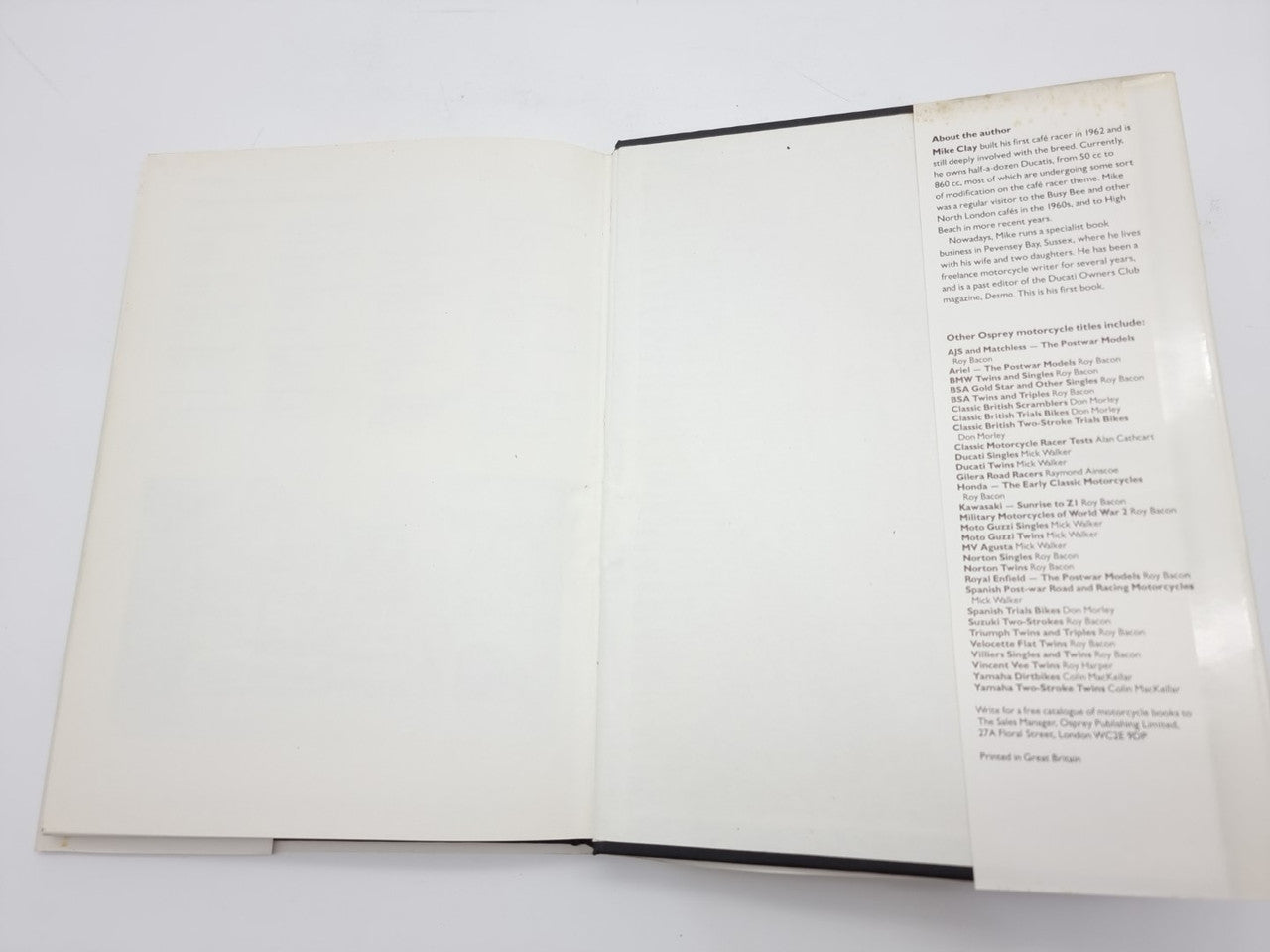 Open hardcover book with blank left page and printed right page