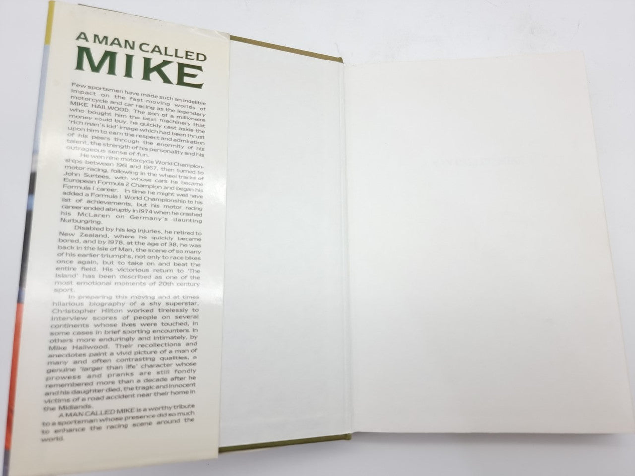 Book with open pages, printed text on the left sheet and blank page right