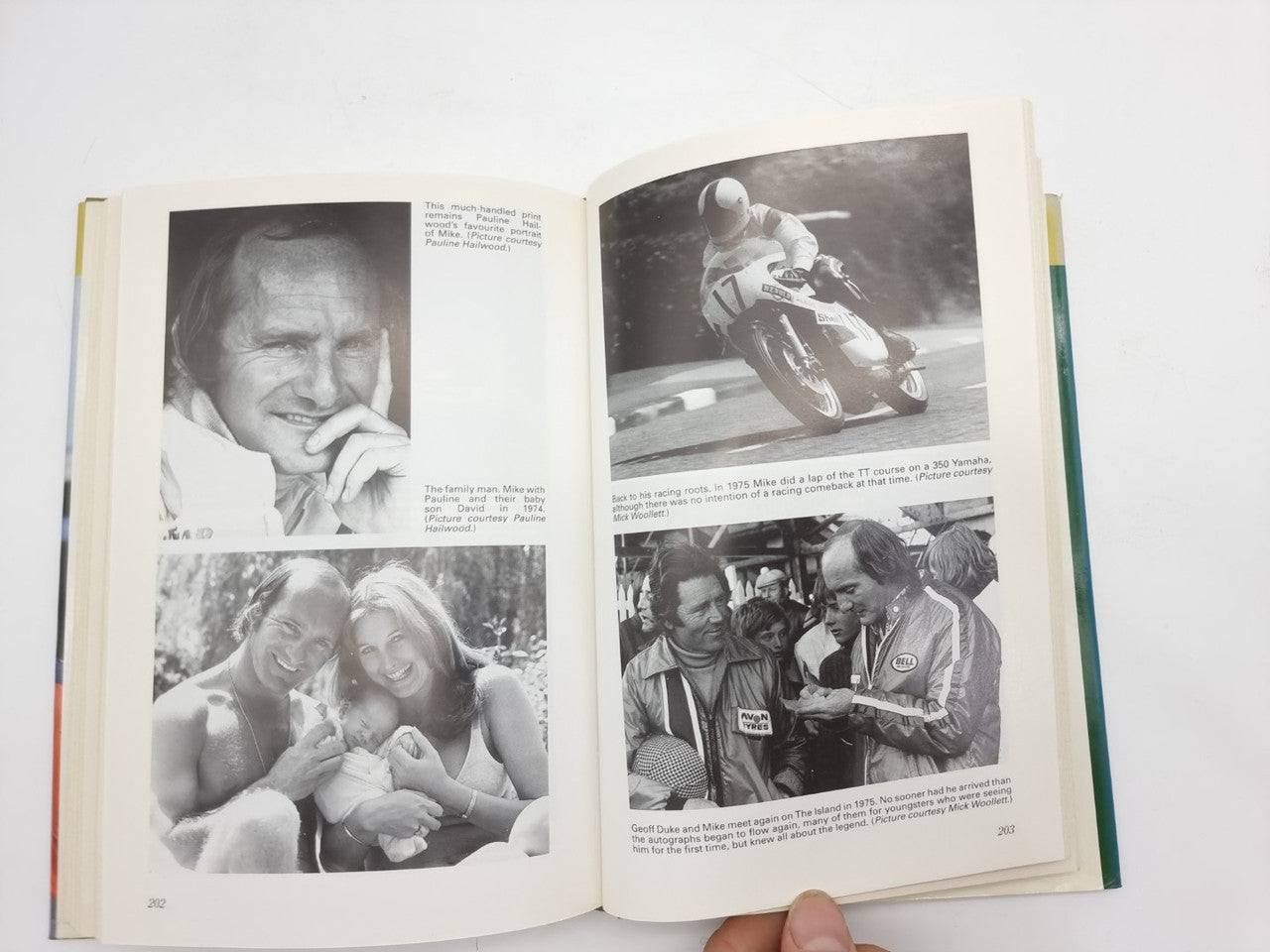 Book open to black-and-white photos, including a portrait and group images