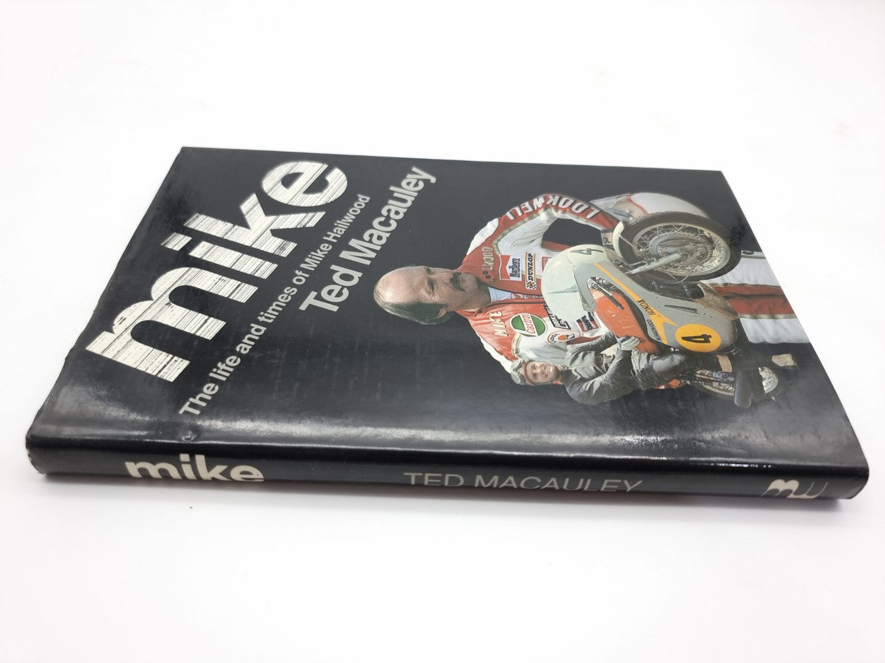 Hardcover book with black cover showing 'mike' title and a racing motorcycle rider.