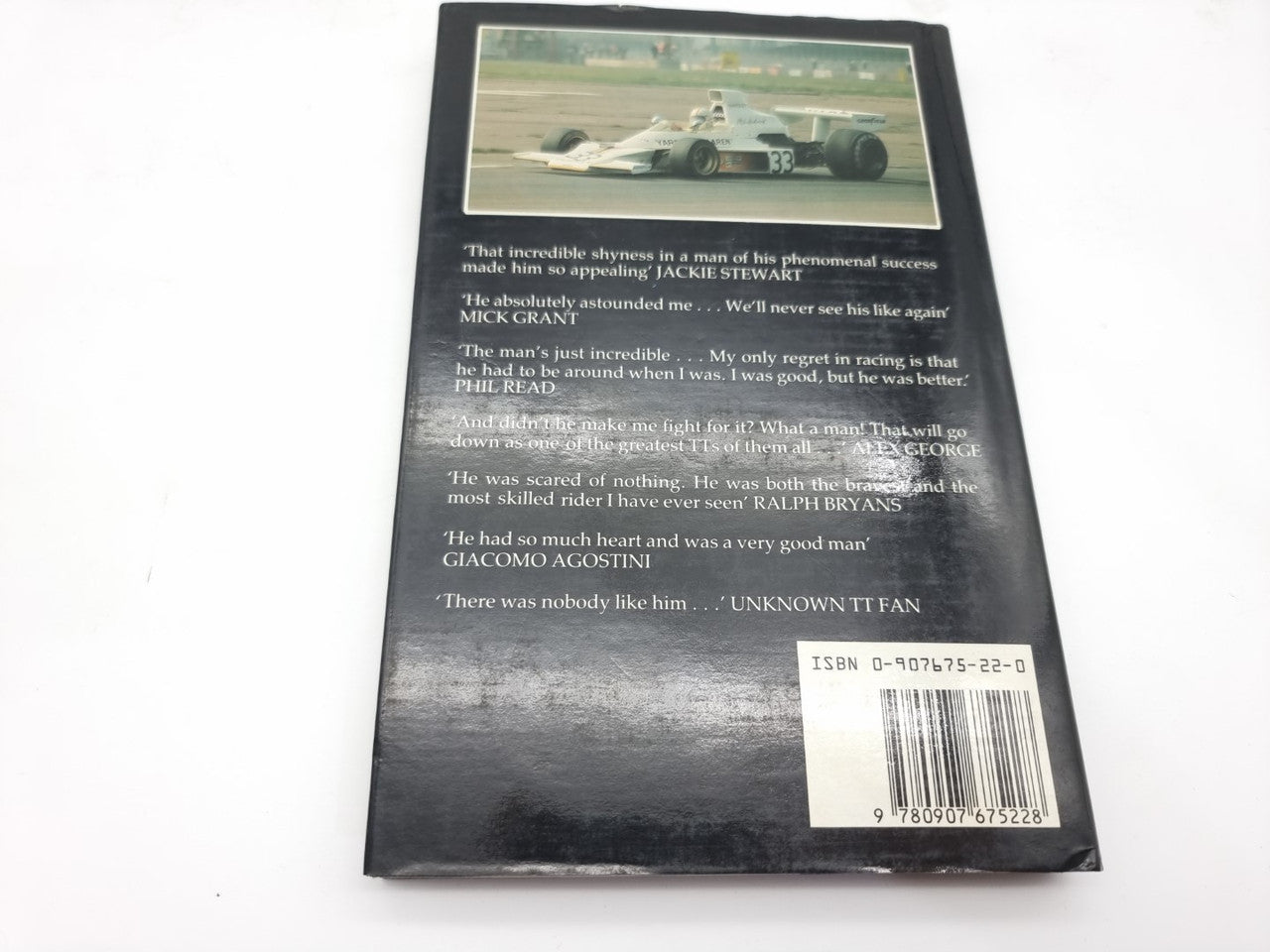 Hardcover book back cover with small race photo, text block, and barcode.