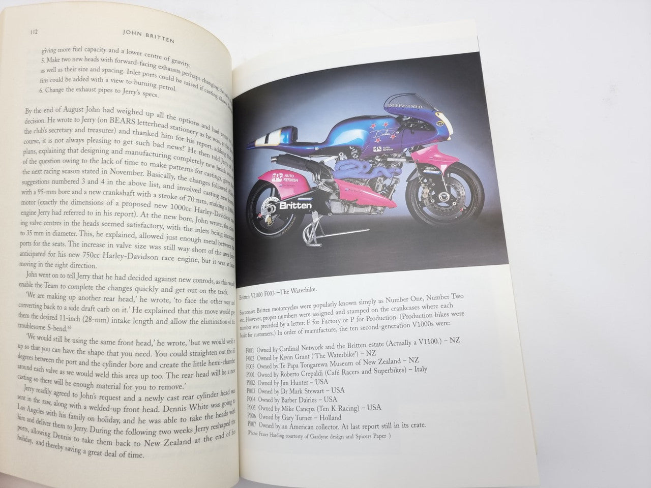 Open book spread with text page and blue pink motorcycle photo page