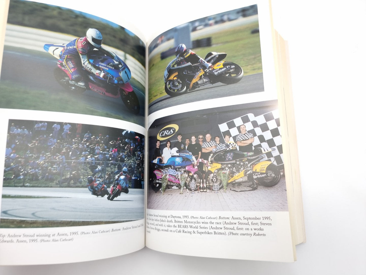 Open book spread with multiple racing track photos and team group photo