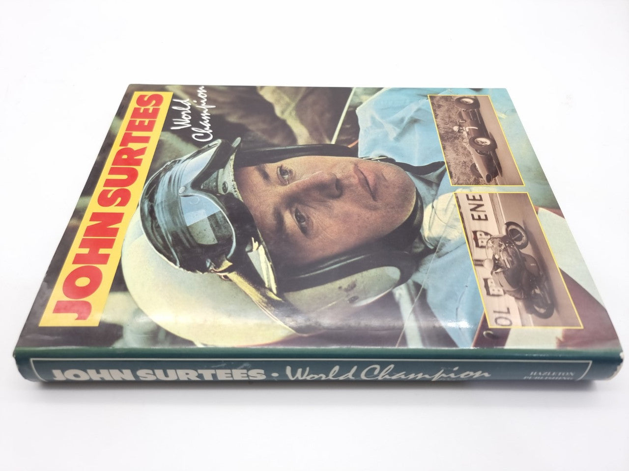 John Surtees World Champion book front cover with helmet portrait and title text