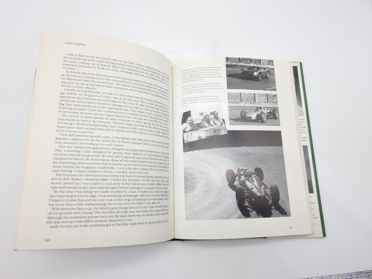 Open John Surtees World Champion book with photo pages and dense text paragraphs
