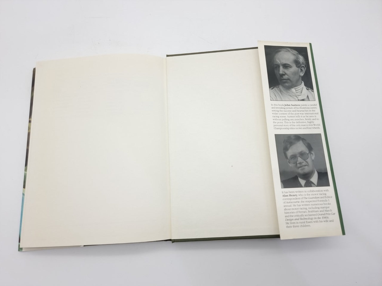 Open John Surtees World Champion book showing two portrait biography photos on right page