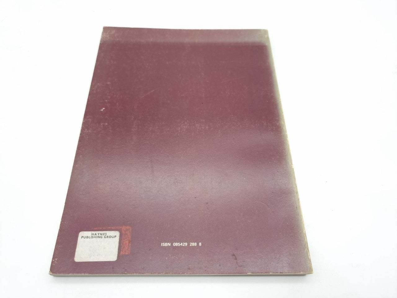 Maroon paperback back cover with small publisher label and barcode-style print