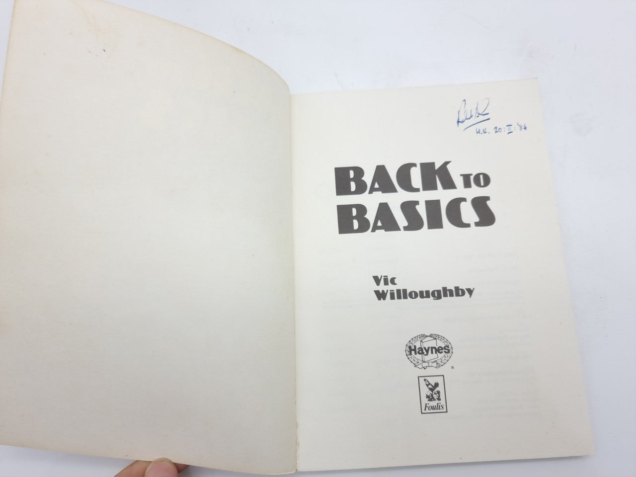 Open paperback book showing title page with author name and publisher logo