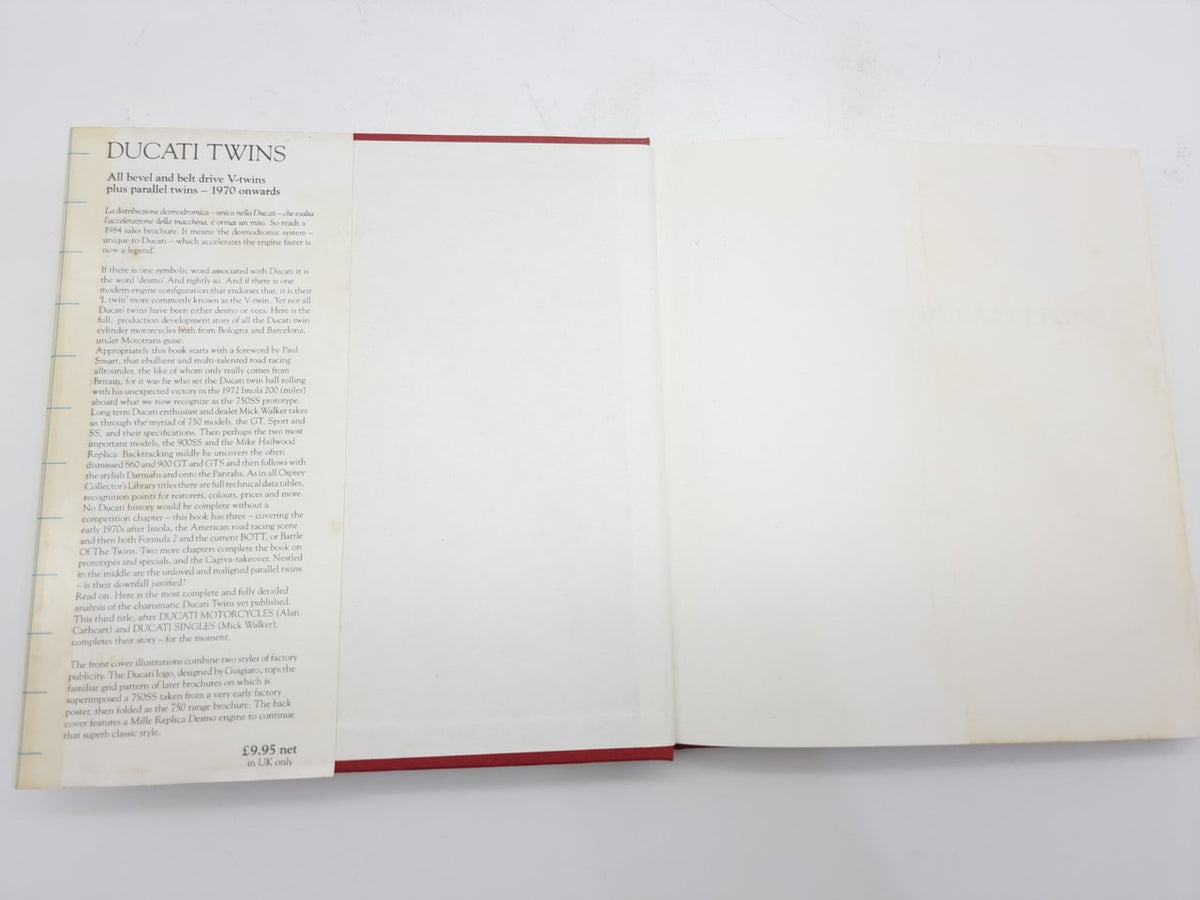 Motorcycle repair book open with a page of text and blank right page