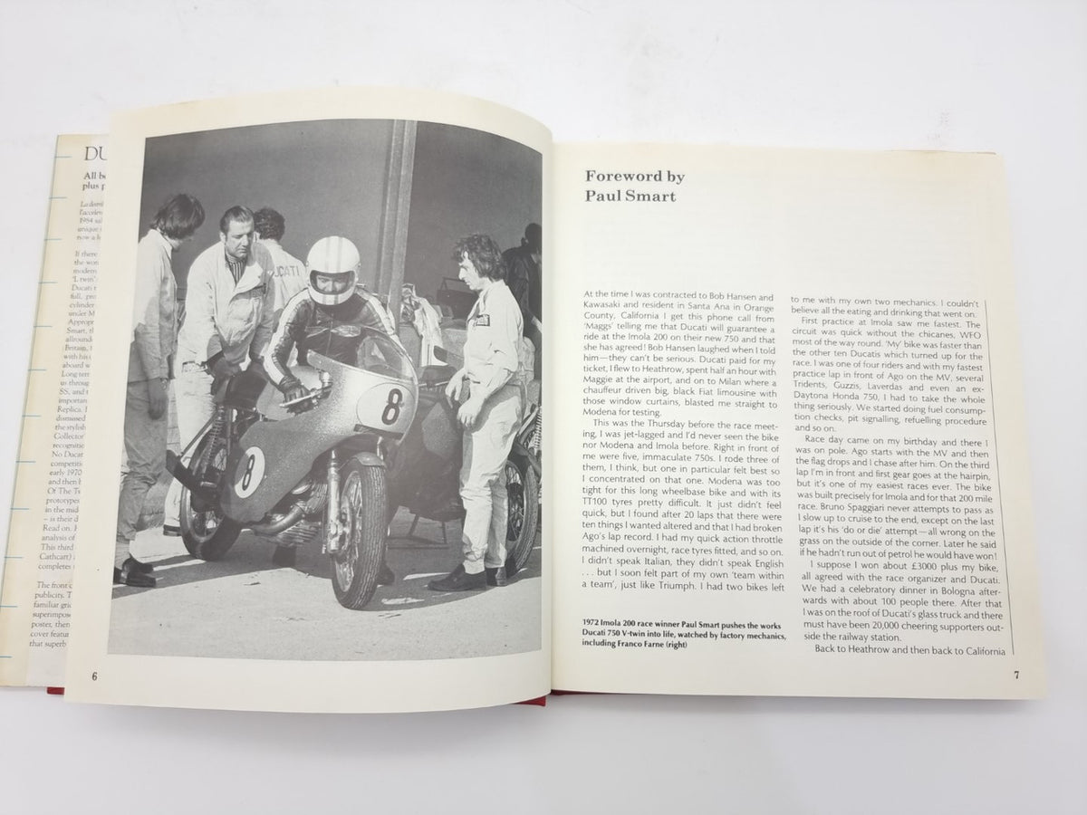 Motorcycle repair book open to foreword page with motorcycle photo