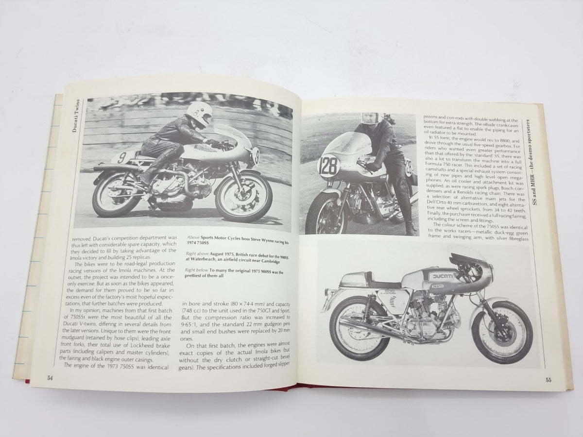 Motorcycle repair book open to motorcycle photo plates with captions