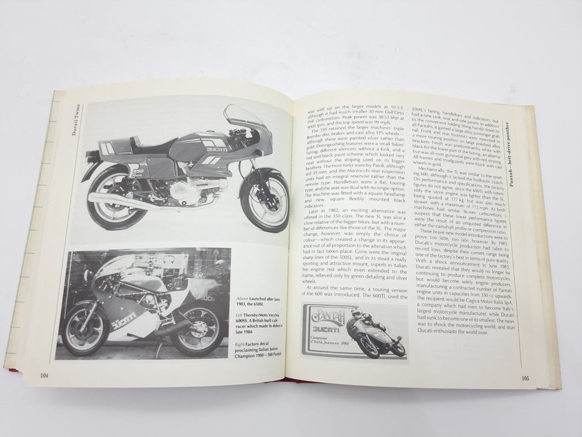 Open book spread with two motorcycle photos and dense text columns