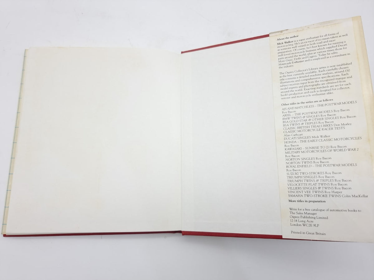 Open book with mostly blank pages and red-edged outer border