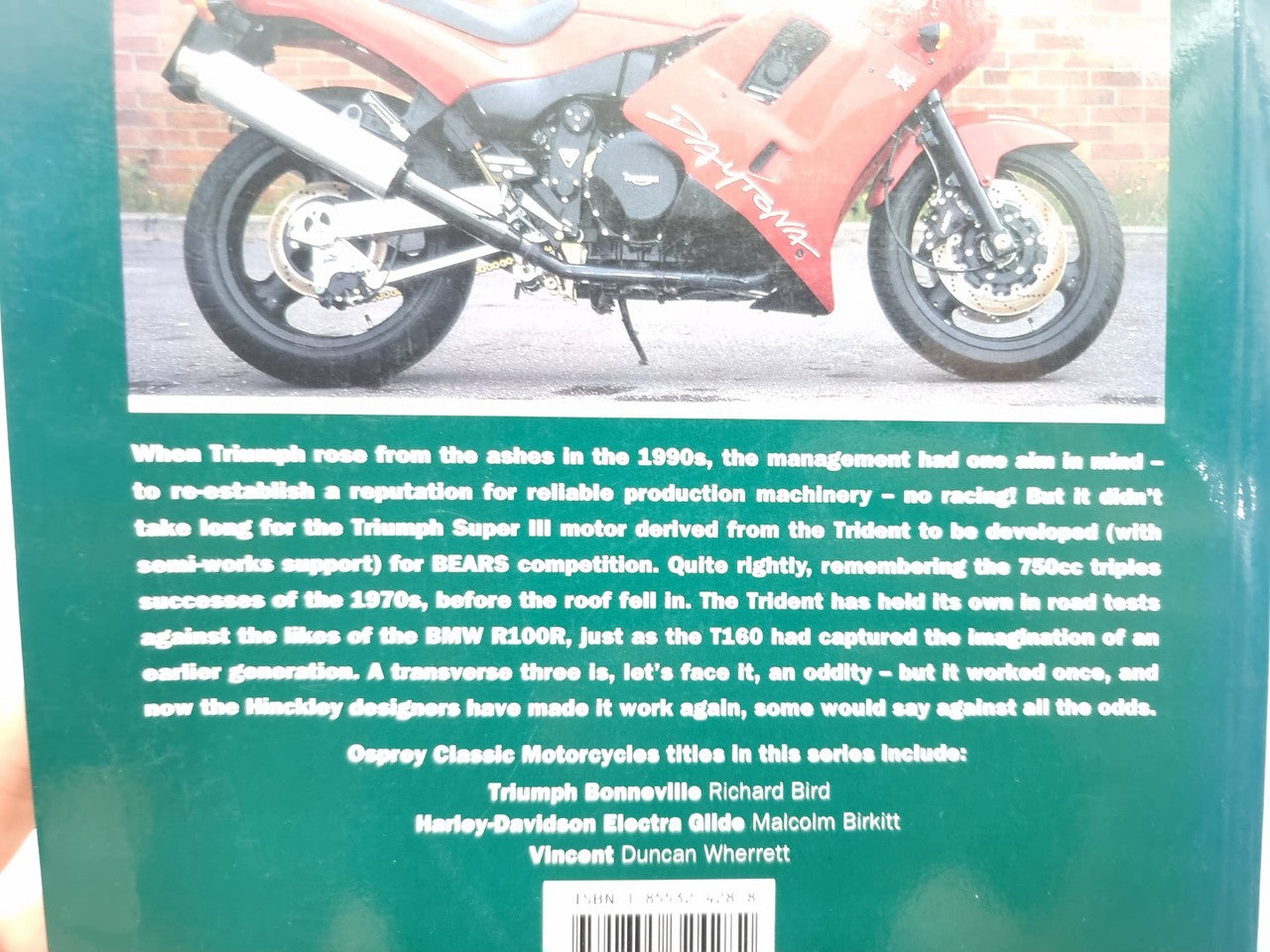Motorcycle book back cover with red and black Triumph-style sport bike illustration