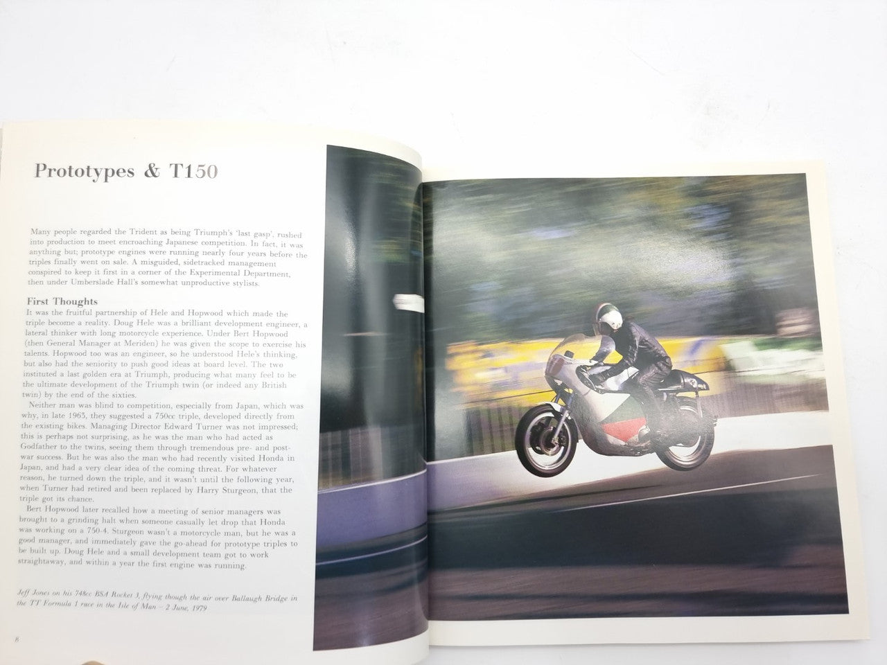 Open hardcover motorcycle photo book with a motorcycle image on the right page