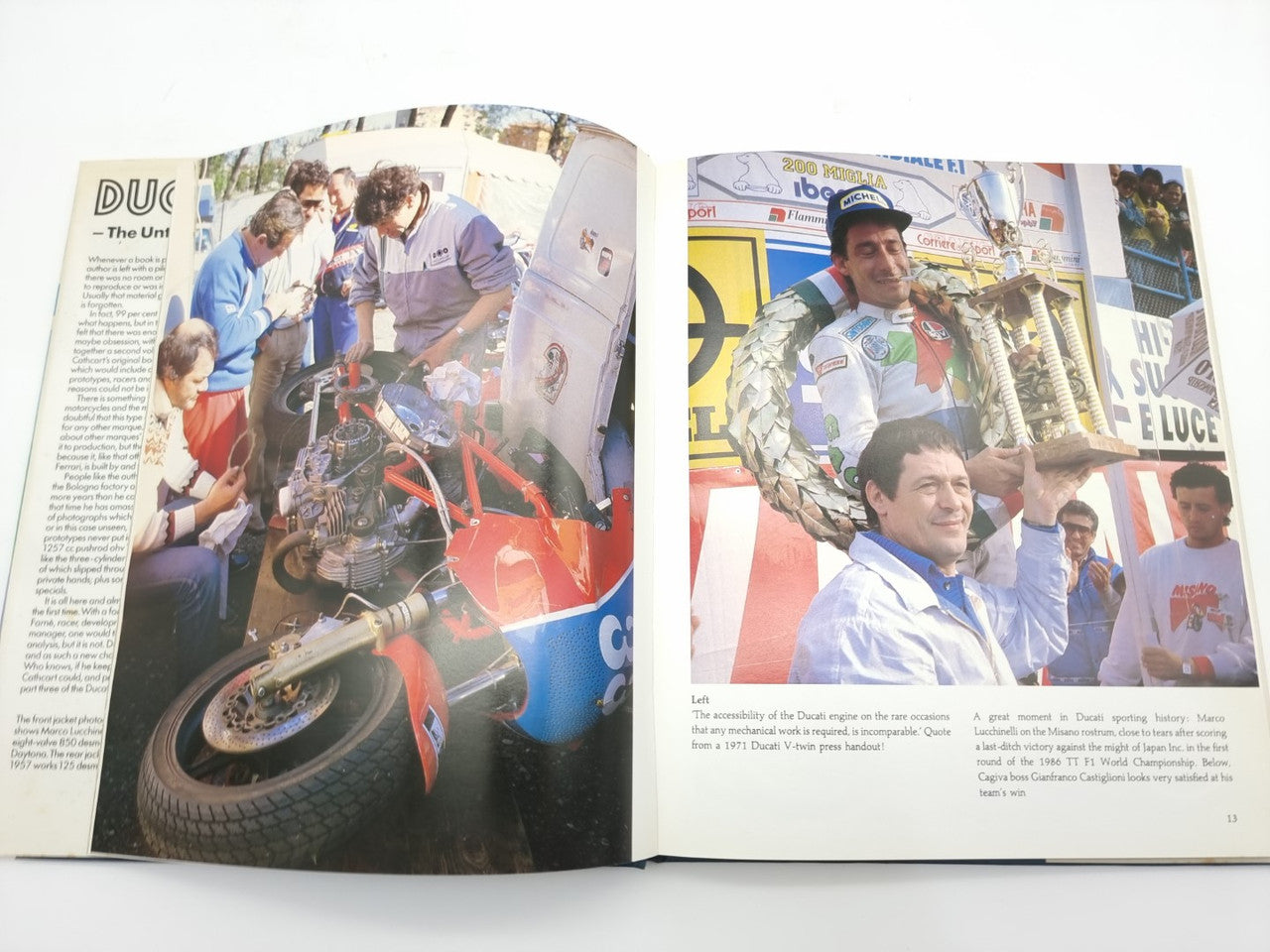 Open Ducati racing book showing race photos and captions on both pages