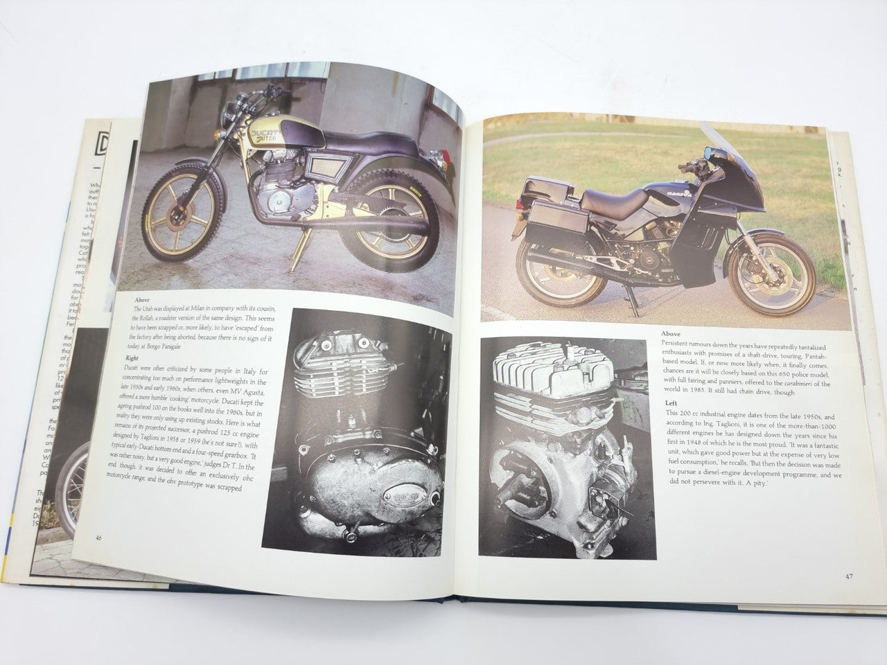 Open Ducati racing book with motorcycle photos and black-and-white engine images