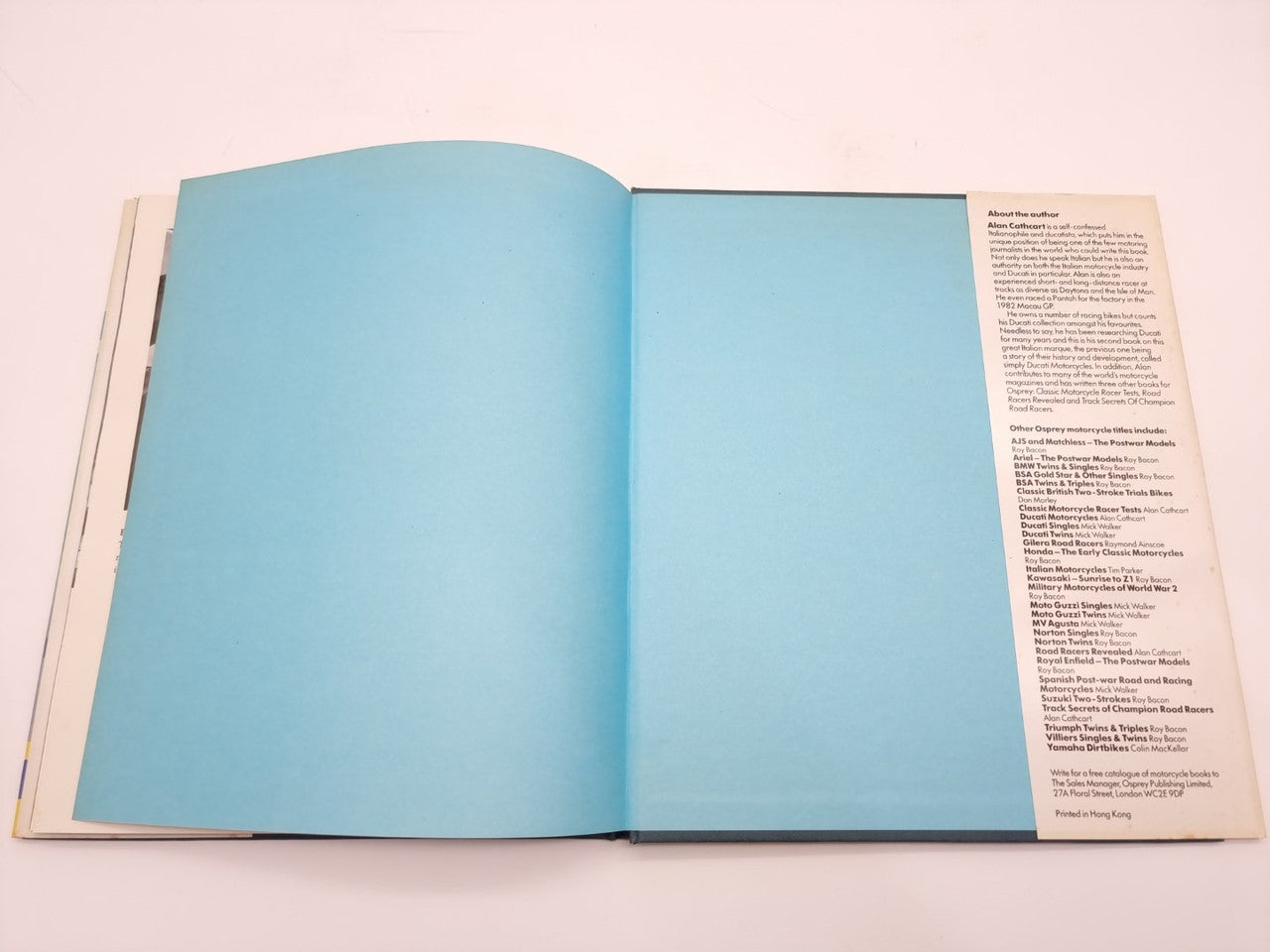 Open book with two blank blue pages and printed text column on the right