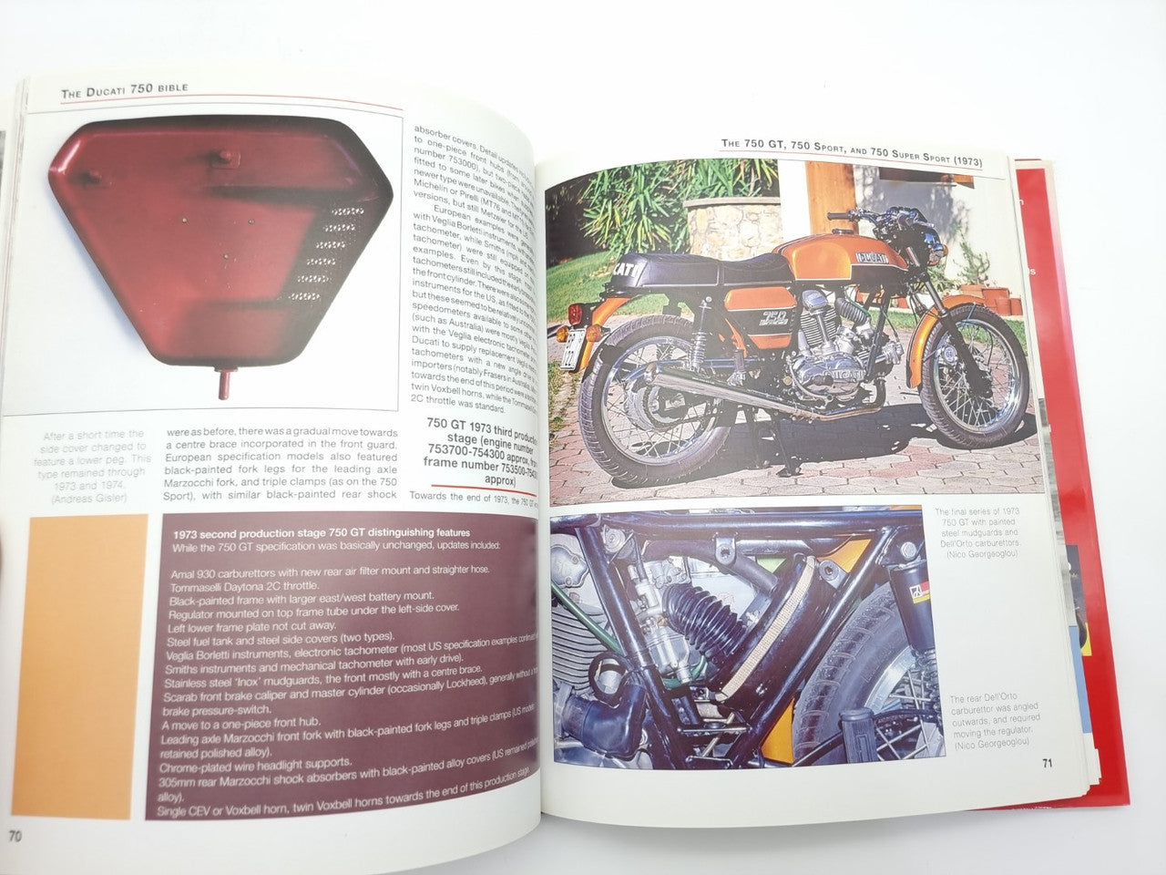 Open motorcycle history book with tail light close-up and color bike detail photos