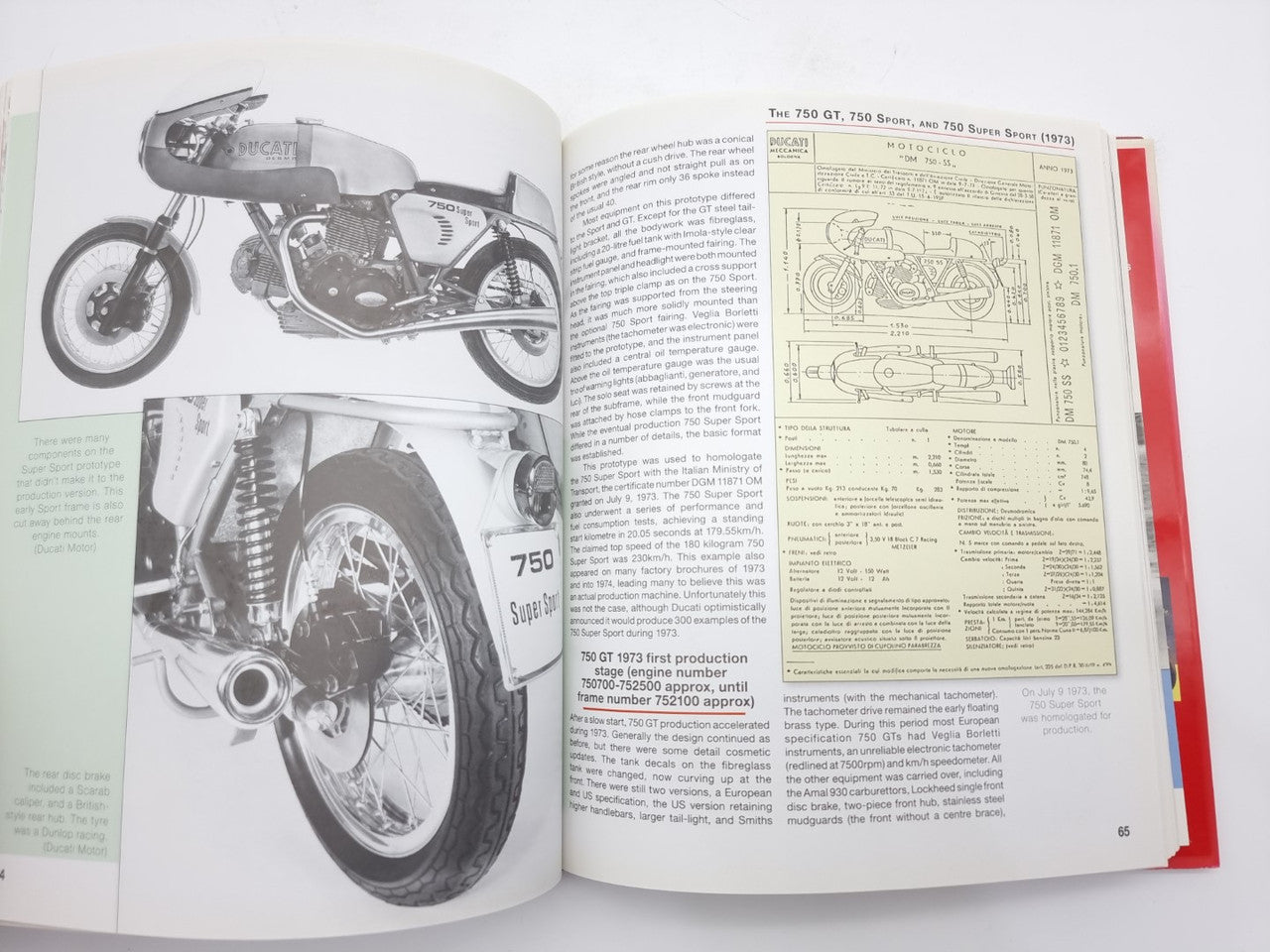 Motorcycle guide book open to pages with bike photo and technical diagram tables