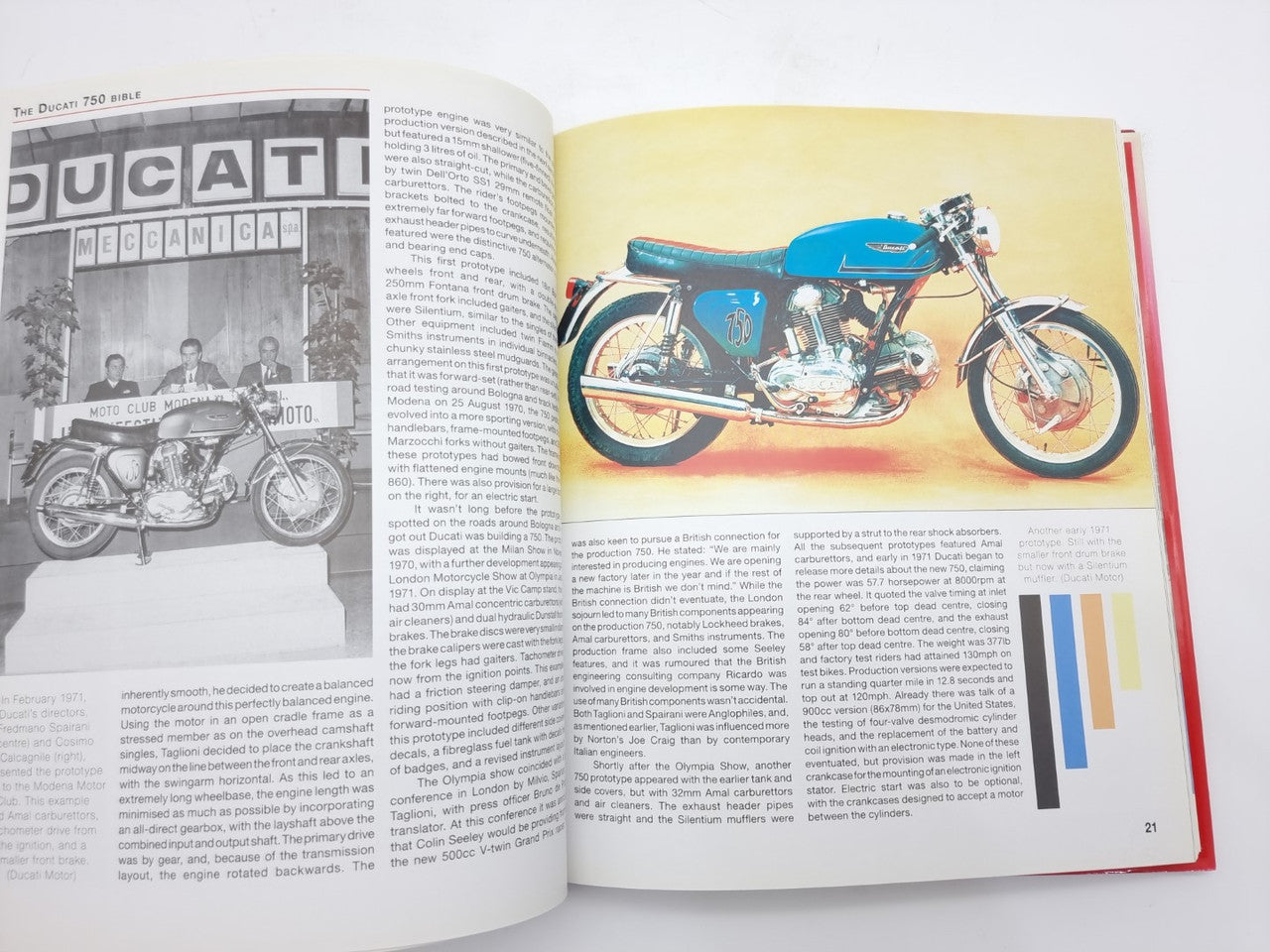 Motorcycle guide book open to page spread with blue motorcycle photo and text