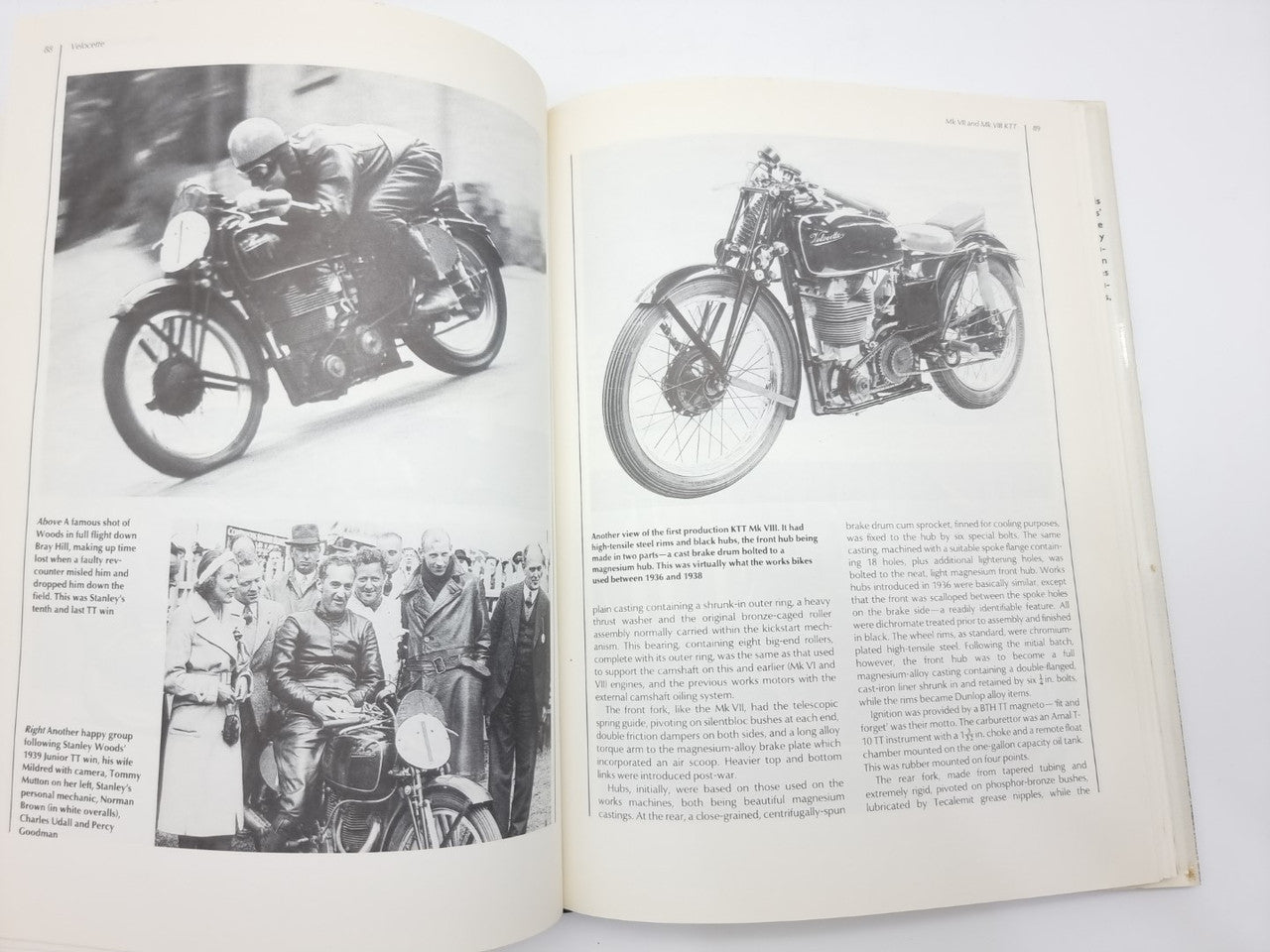 Open book pages with black-and-white motorcycle photos and a group scene