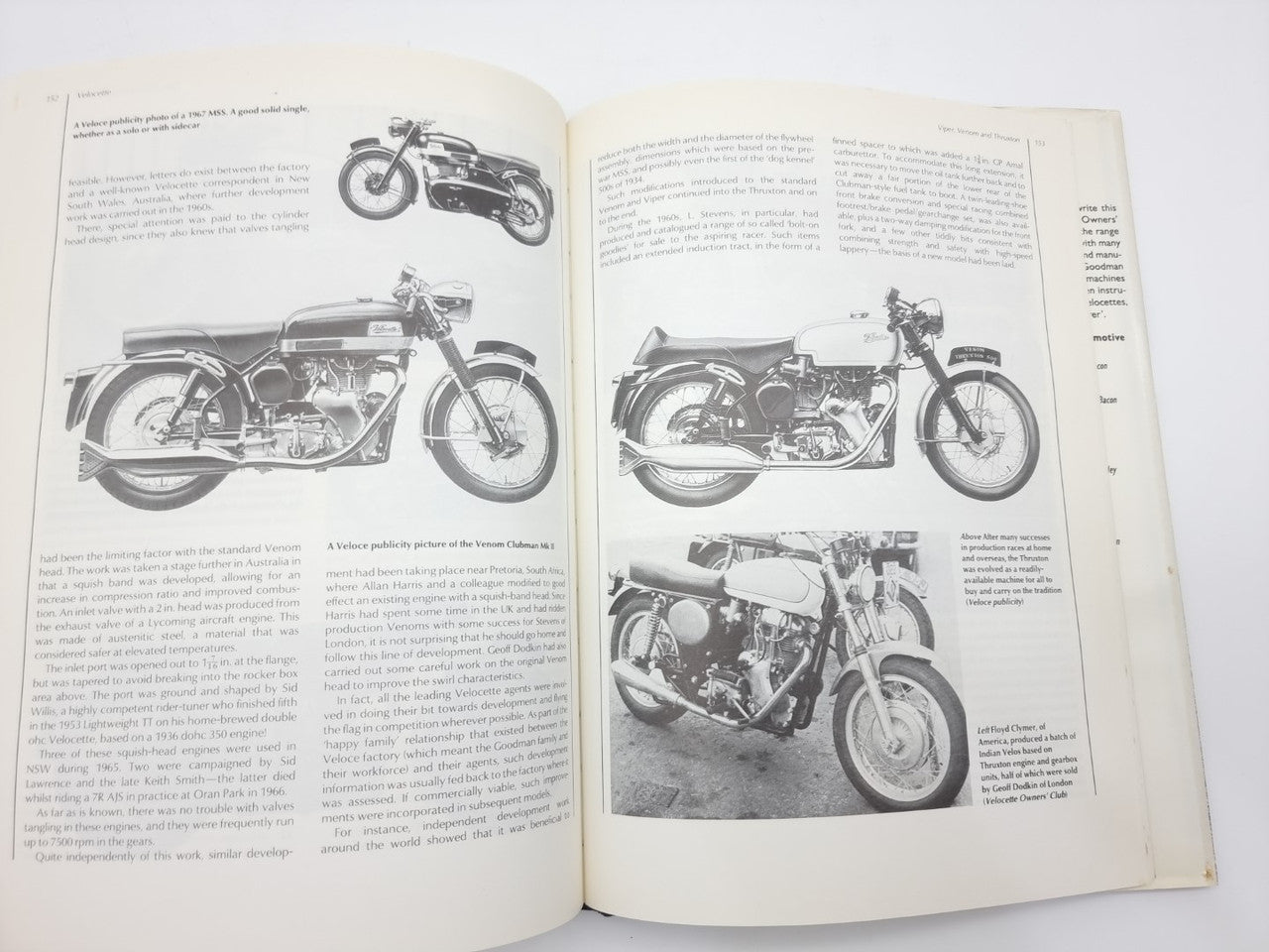 Open book with black-and-white images of a vintage motorcycle from multiple angles