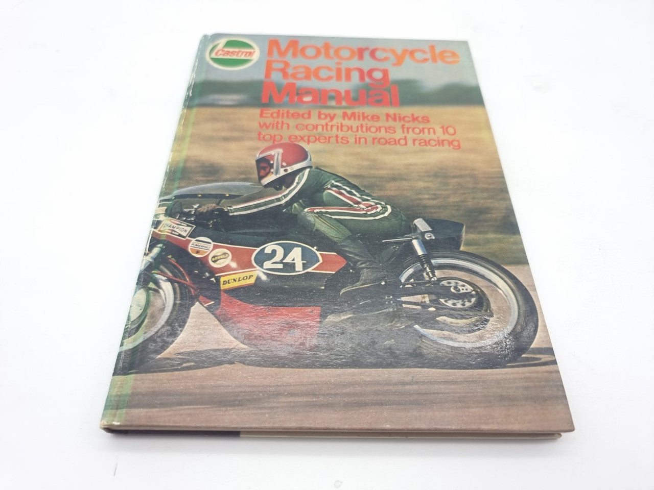Motorcycle racing manual with illustrated cover featuring a rider and the number 24 on a bike