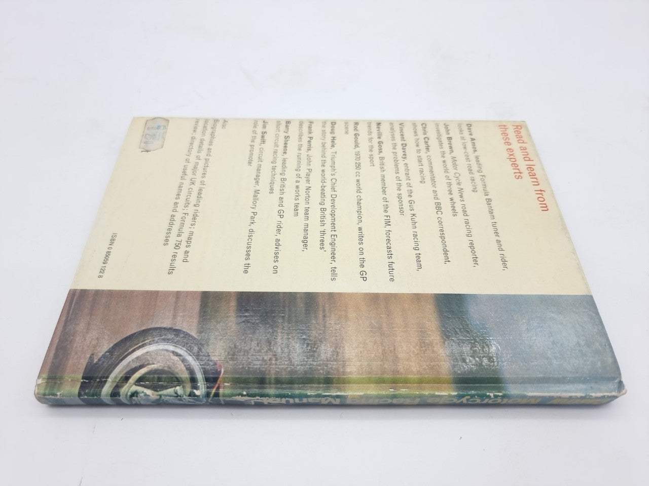 Motorcycle racing manual back cover with small text and a large circuit illustration
