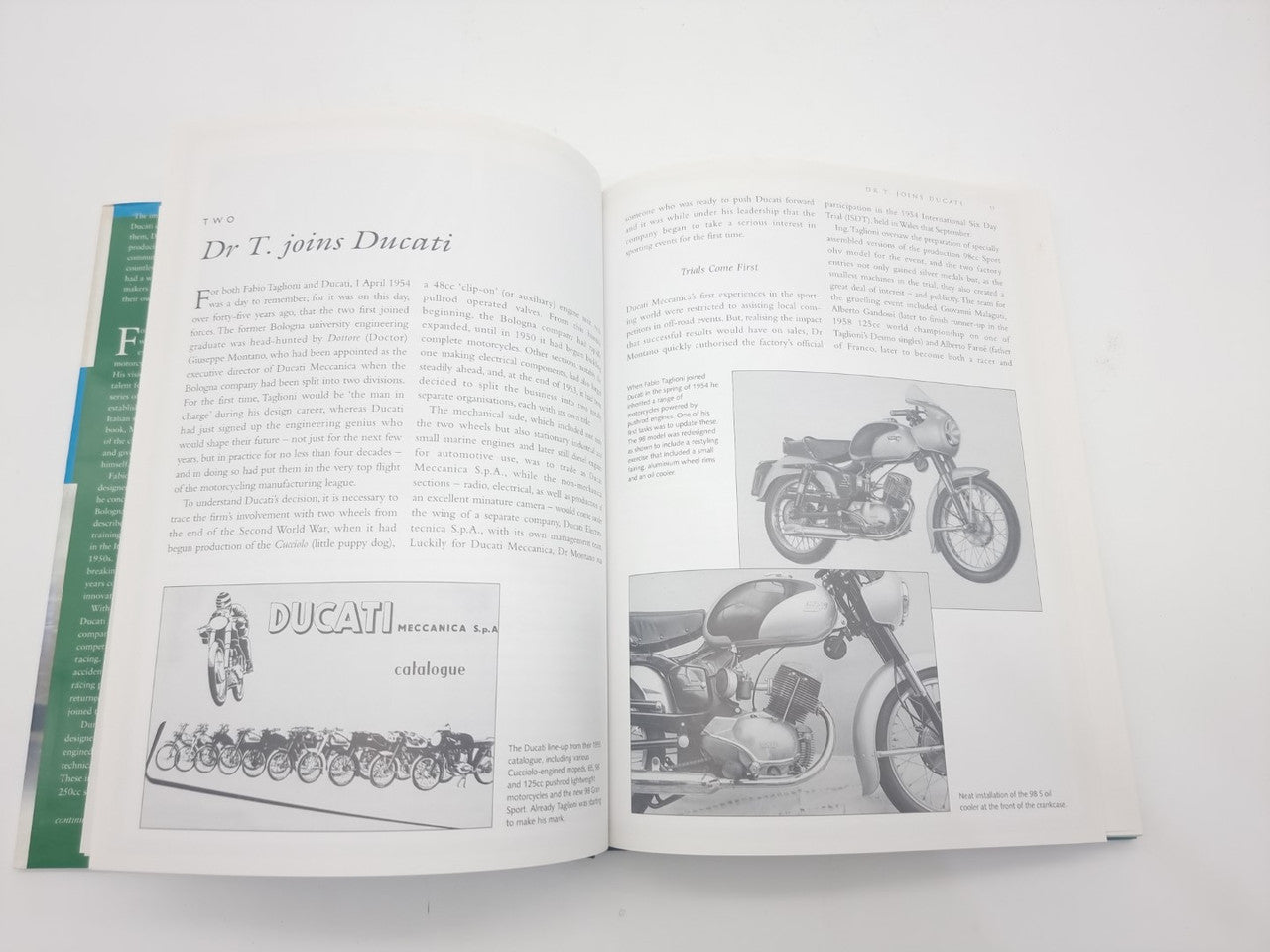Open book with text columns and motorcycle photo inset on the right page