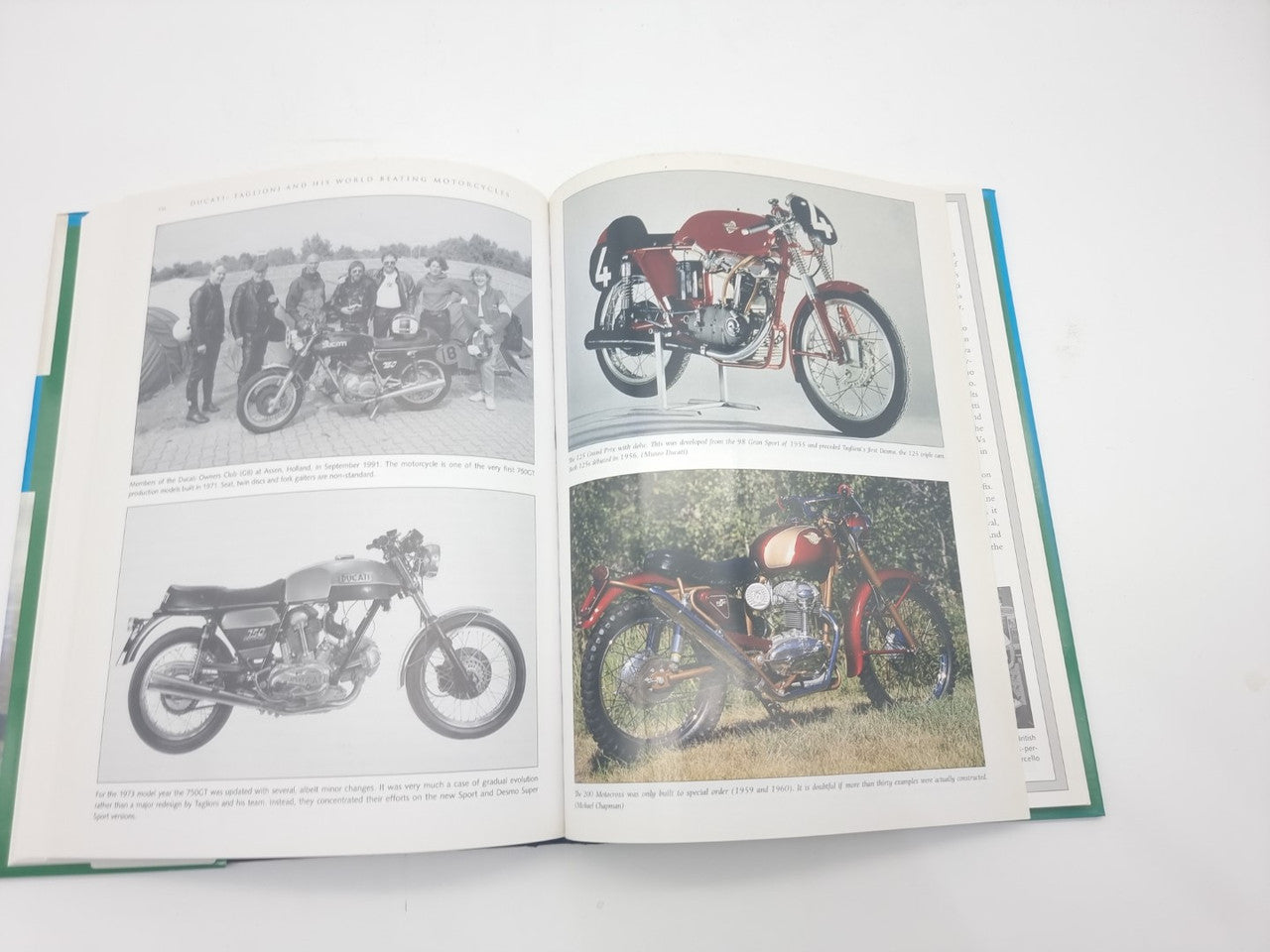 Motorcycles book opened to pages with classic Ducati photos and captions