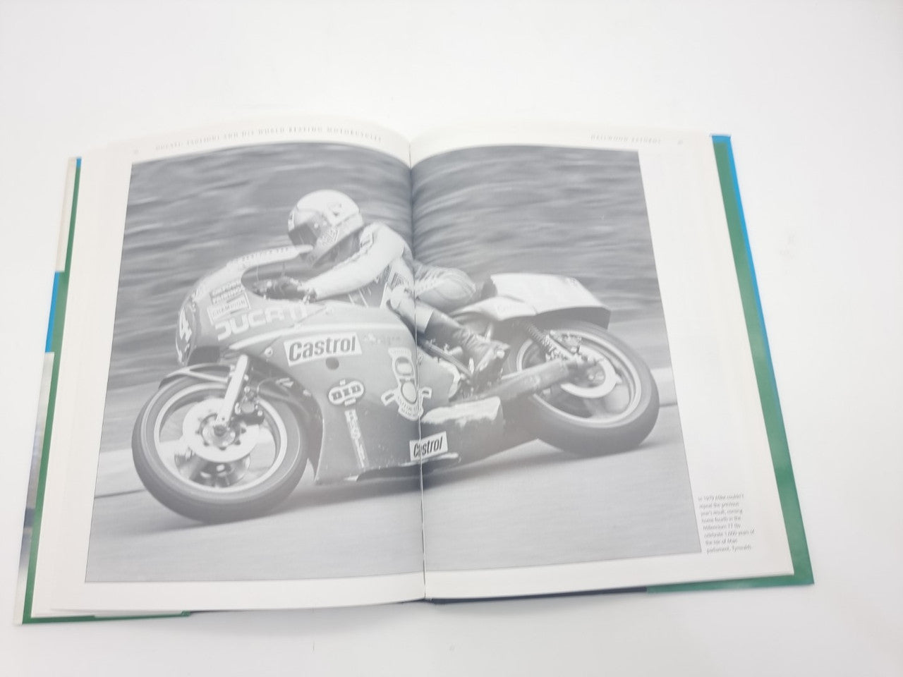 Motorcycles book opened with a black-and-white racing motorcycle photo page